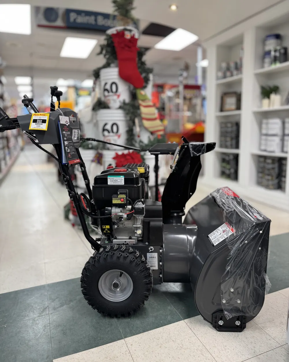 A two-stage snow thrower in the store